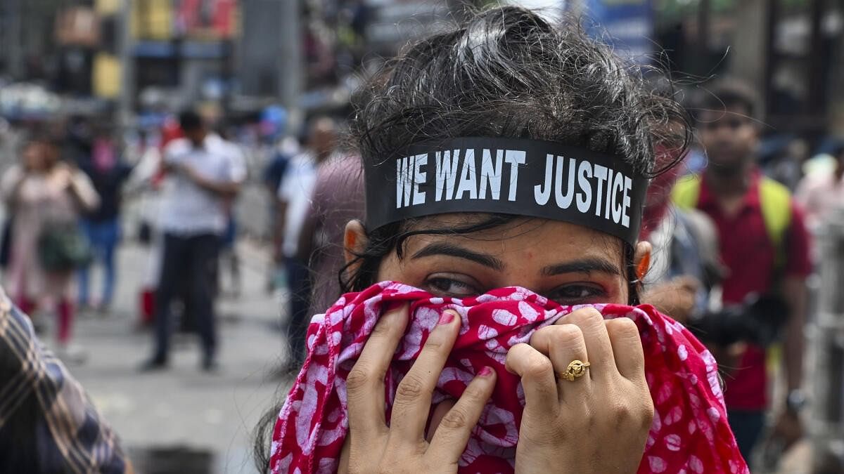 <div class="paragraphs"><p>A student uses a scarf to cover her face after security personnel fired tear gas shells to disperse students during a protest march towards West Bengal Secretariat over the alleged sexual assault and murder of a trainee doctor, in Kolkata, Tuesday, August 27, 2024.</p></div>