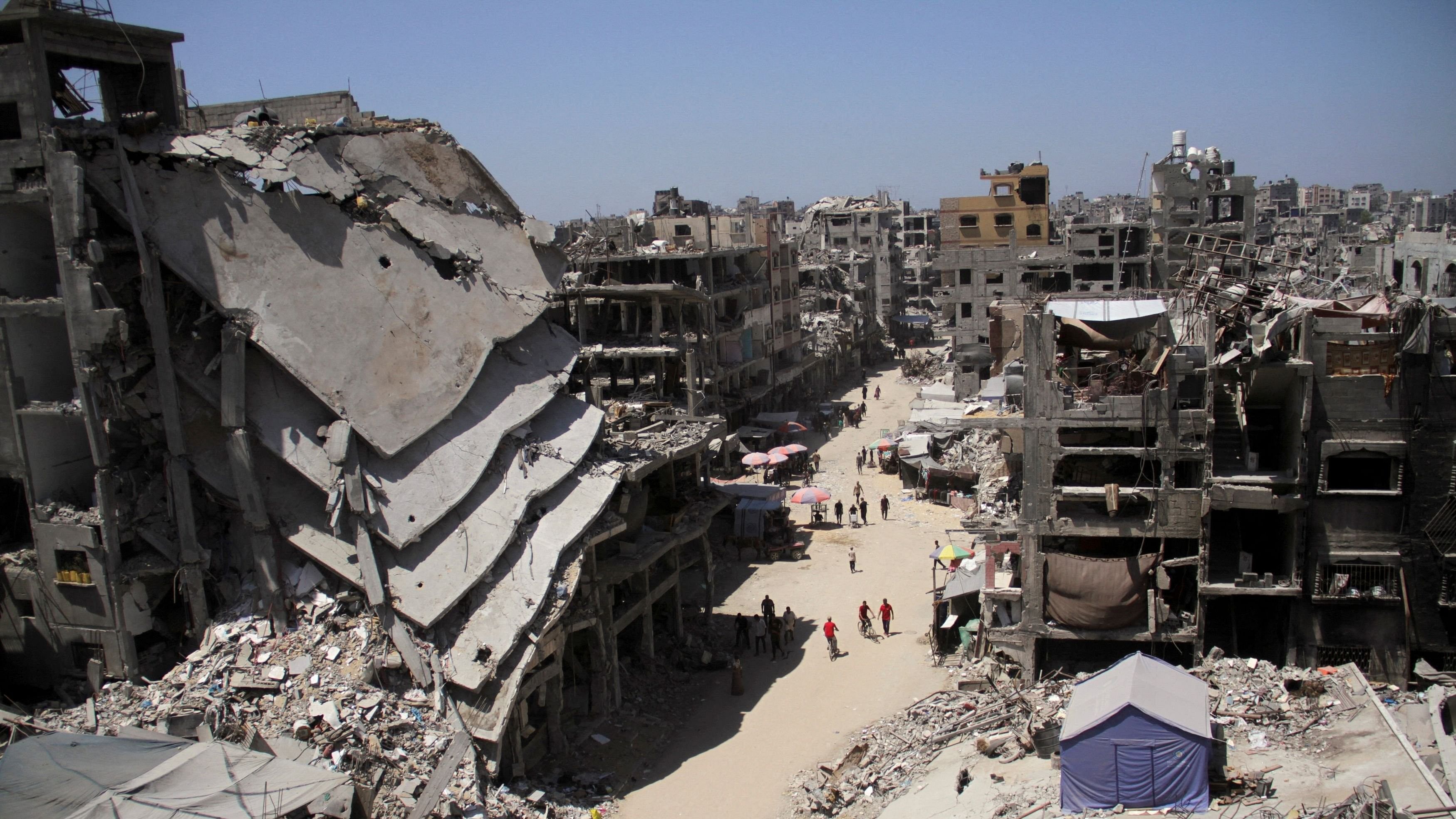 <div class="paragraphs"><p>Palestinians walk near the ruins of houses destroyed during the Israeli offensive, amid Israel-Hamas conflict, in Jabalia in the northern Gaza Strip.</p></div>