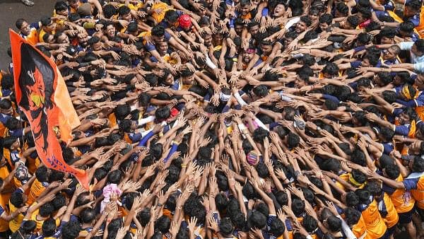 <div class="paragraphs"><p>Devotees pray before they form a human pyramid to break the 'dahi handi', an earthen pot filled with curd, as part of 'Janmashtami' festival celebrations, at Dadar in Mumbai, Tuesday, Aug. 27, 2024. </p></div>