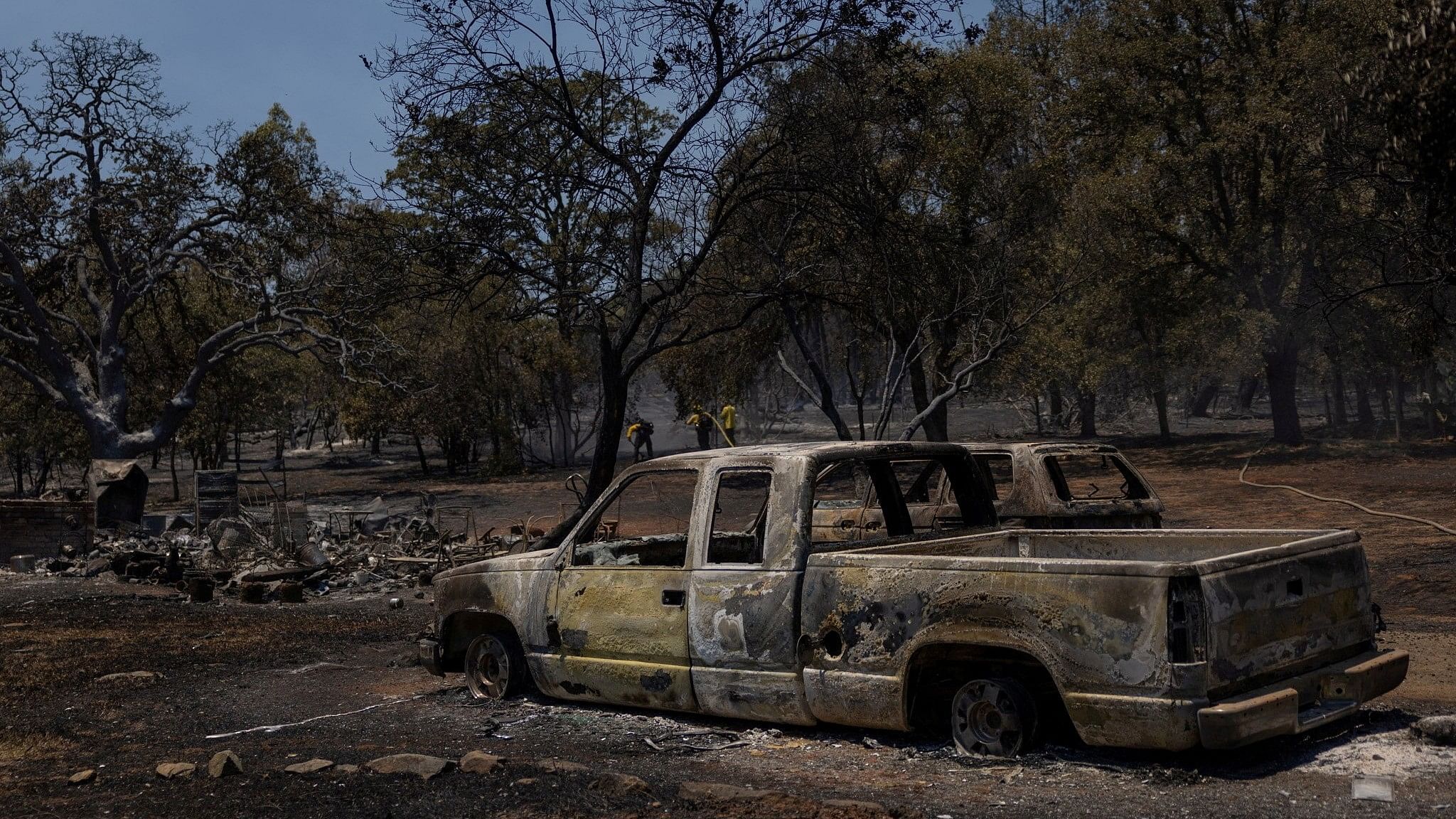 <div class="paragraphs"><p>Firefighters work near burned vehicles after the Thompson fire affected a neighborhood near Oroville, California.</p></div>