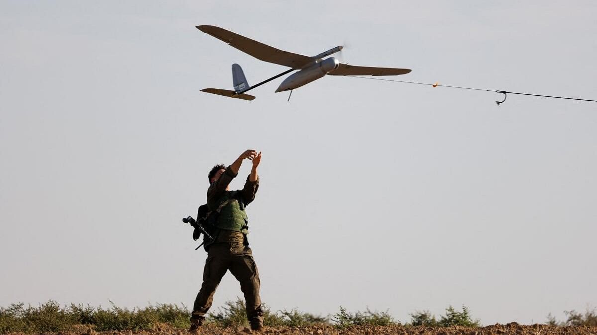 <div class="paragraphs"><p>An israeli soldier launches a drone towards Gaza, near the Israel-Gaza border, amid the Israel-Hamas conflict.</p></div>