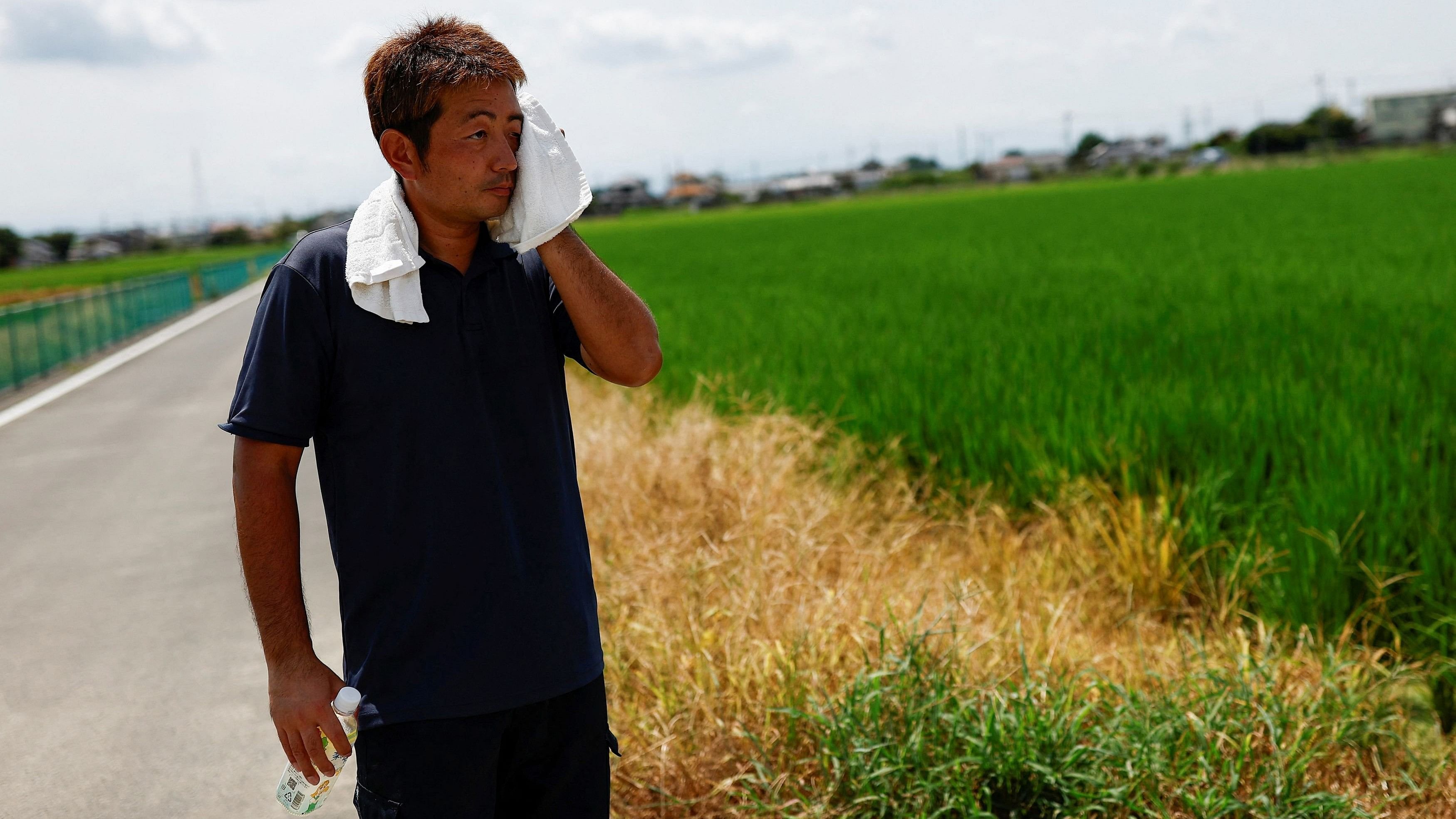 <div class="paragraphs"><p>Yukihiro Kurosawa, a 39-year-old farmer, wipes his sweat during a hot summer day, near his fields in Meiwa, Gunma prefecture, Japan.</p></div>