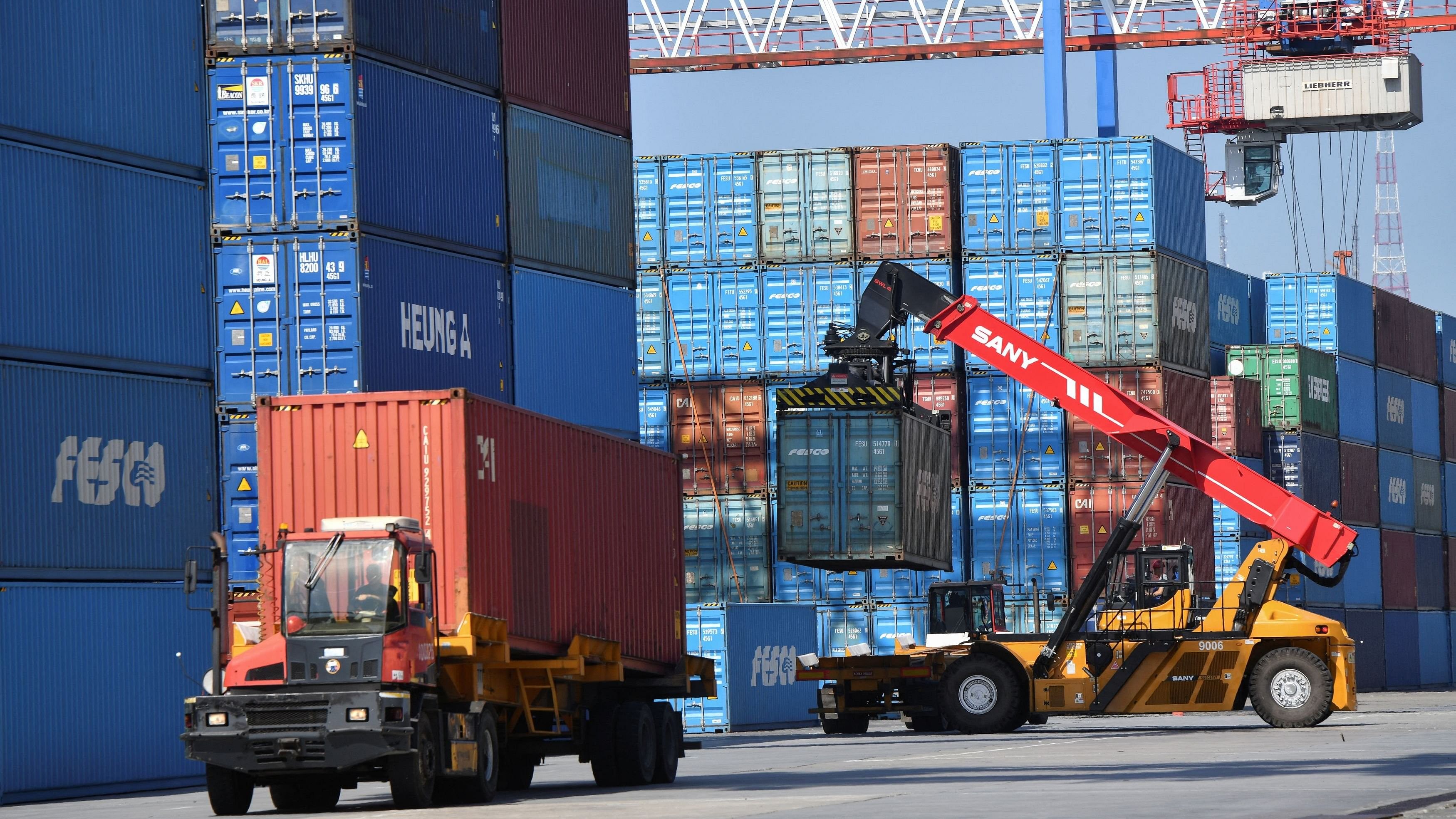 <div class="paragraphs"><p>A worker operates a crane while removing a shipping container at a commercial port.</p></div>