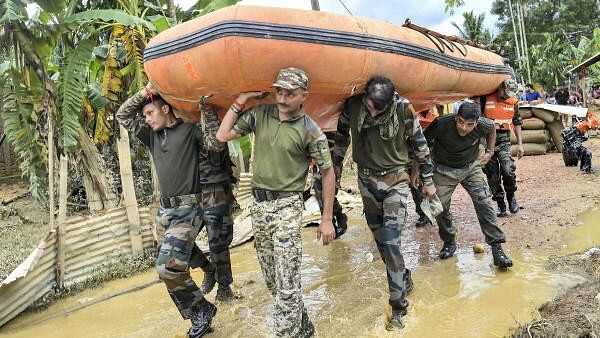 <div class="paragraphs"><p>Security personnel are seen carrying a boat during a rescue and relief operation at flood-affected Amarpur area, in Gomati district</p></div>