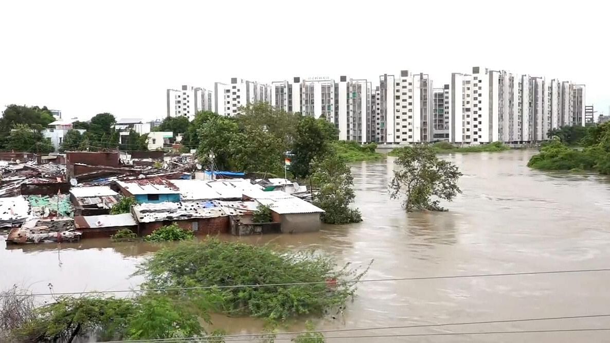 <div class="paragraphs"><p>Houses partially submerged following heavy rainfall, at Akota stadium area in Vadodara.</p></div>