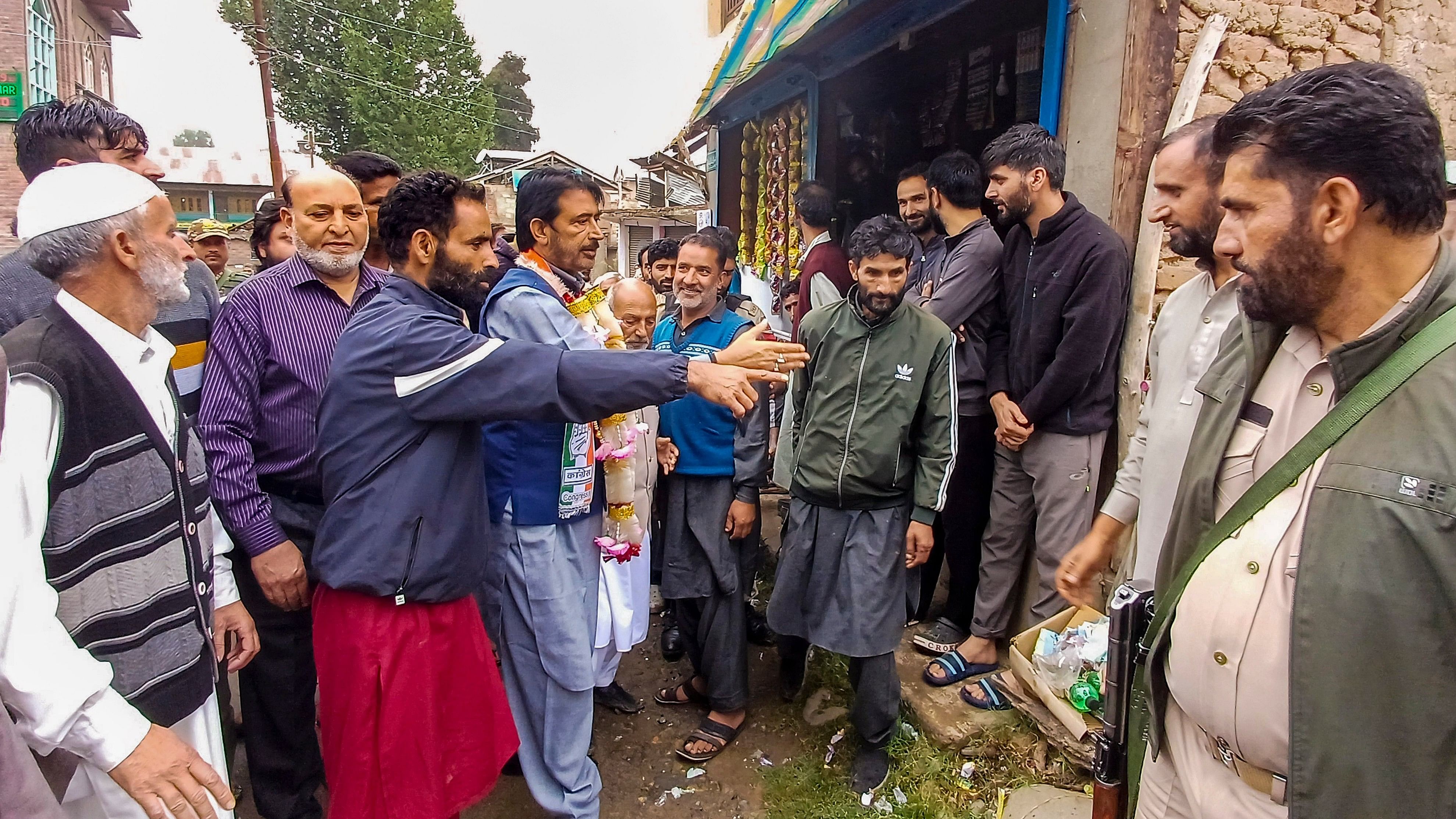 <div class="paragraphs"><p>Congress leader Ghulam Ahmad Mir with others campaigns ahead of Jammu and Kashmir Assembly elections, in Anantnag district, Thursday.</p></div>