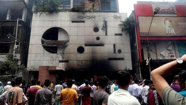 <div class="paragraphs"><p>People gather in front of the ransacked Awami League's central office in the aftermath of the prime minister's resignation, in Dhaka, Bangladesh, 06 August 2024.</p></div>