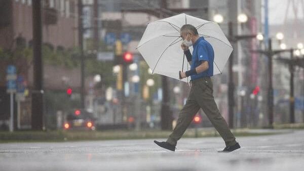 <div class="paragraphs"><p>A passerby holding an umbrella walks in heavy rains caused by Typhoon Shanshan in Kagoshima.</p></div>