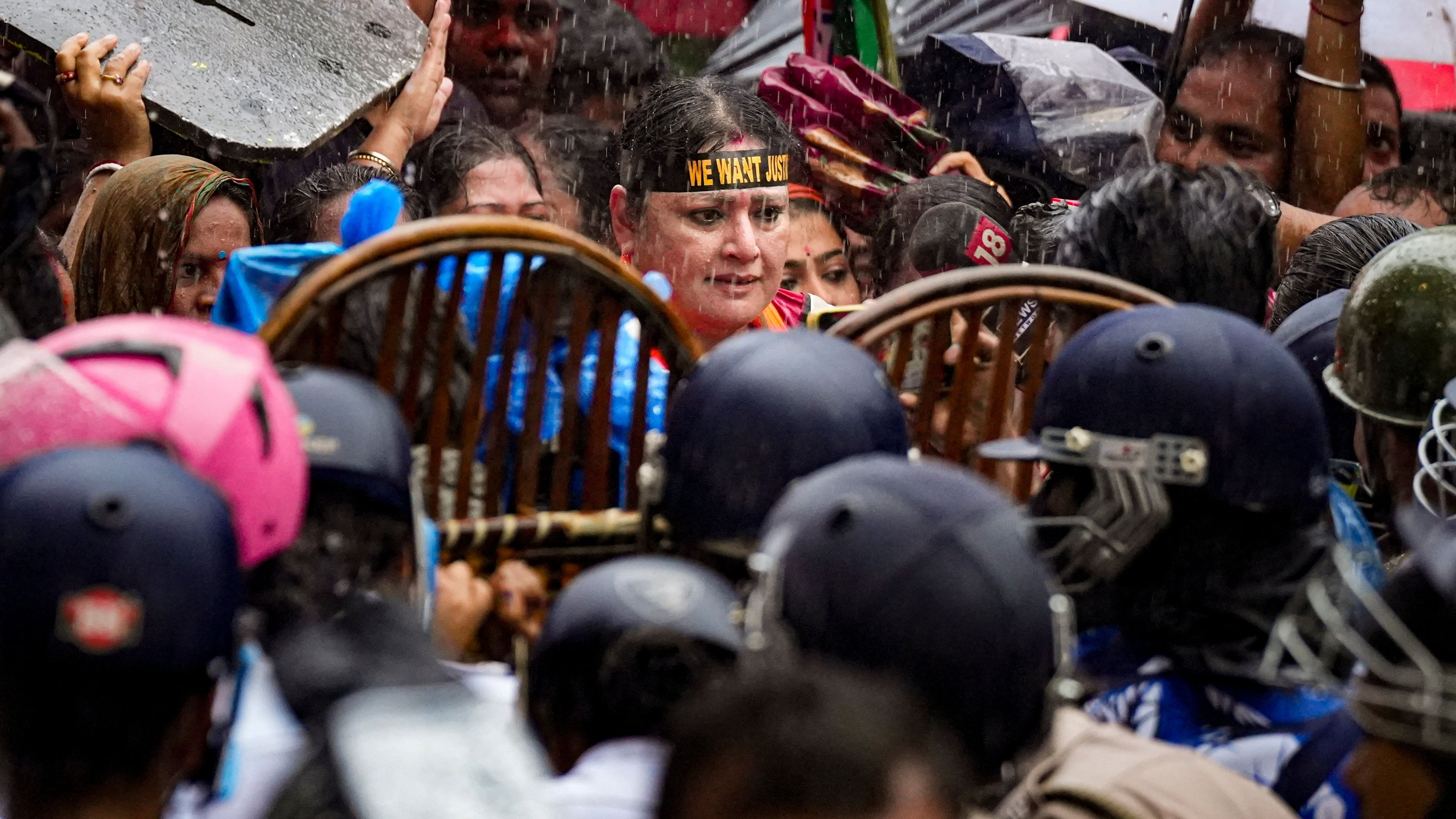 <div class="paragraphs"><p>BJP leader Agnimitra Paul with BJP Mahila Morcha activists and others being stopped by the police amid rainfall during a protest march towards West Bengal Commission for Women.</p></div>