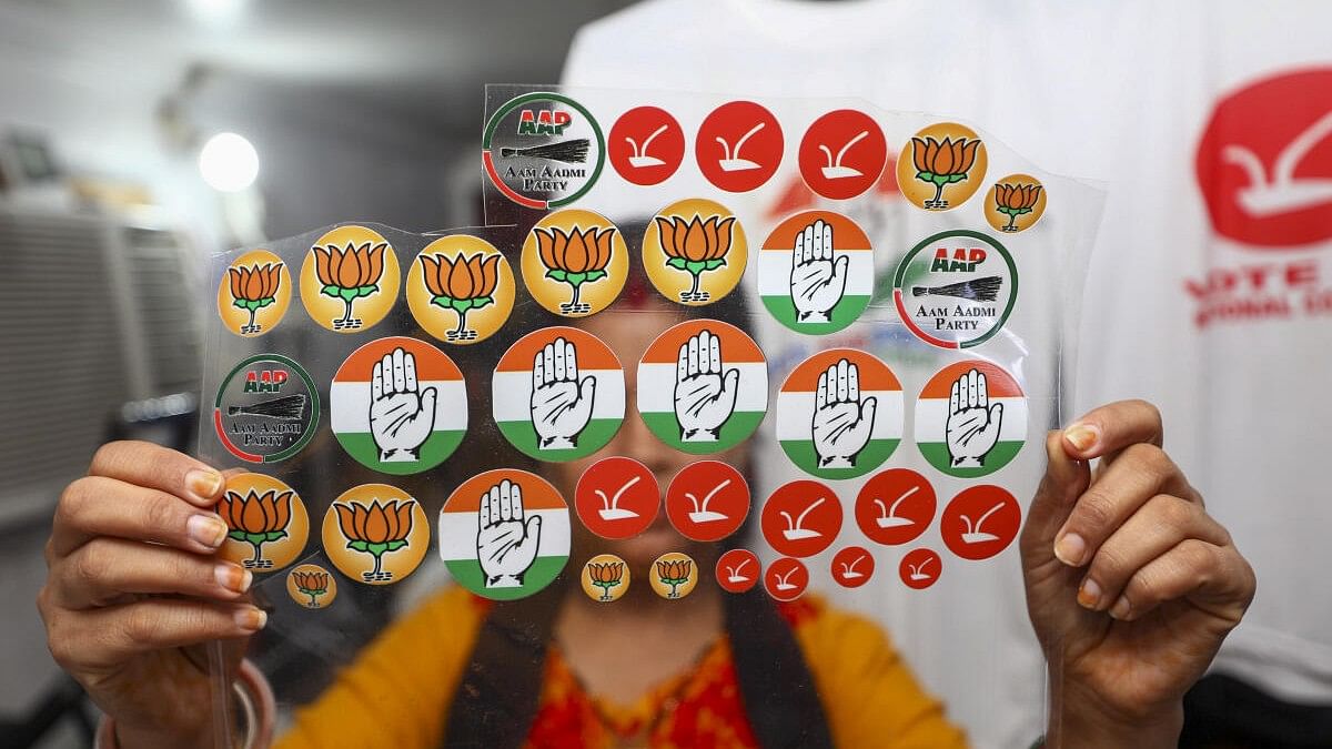 <div class="paragraphs"><p>A shopkeeper shows stickers of different political parties’ logos being sold at a photography shop ahead of the upcoming Assembly elections, in Jammu.</p></div>