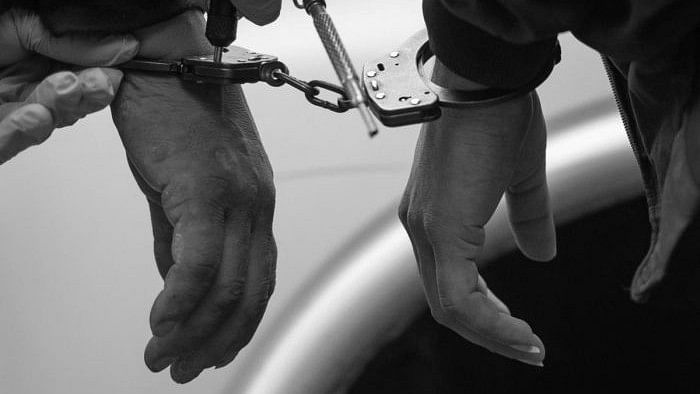 <div class="paragraphs"><p>Representative image showing two people in handcuffs.</p></div>