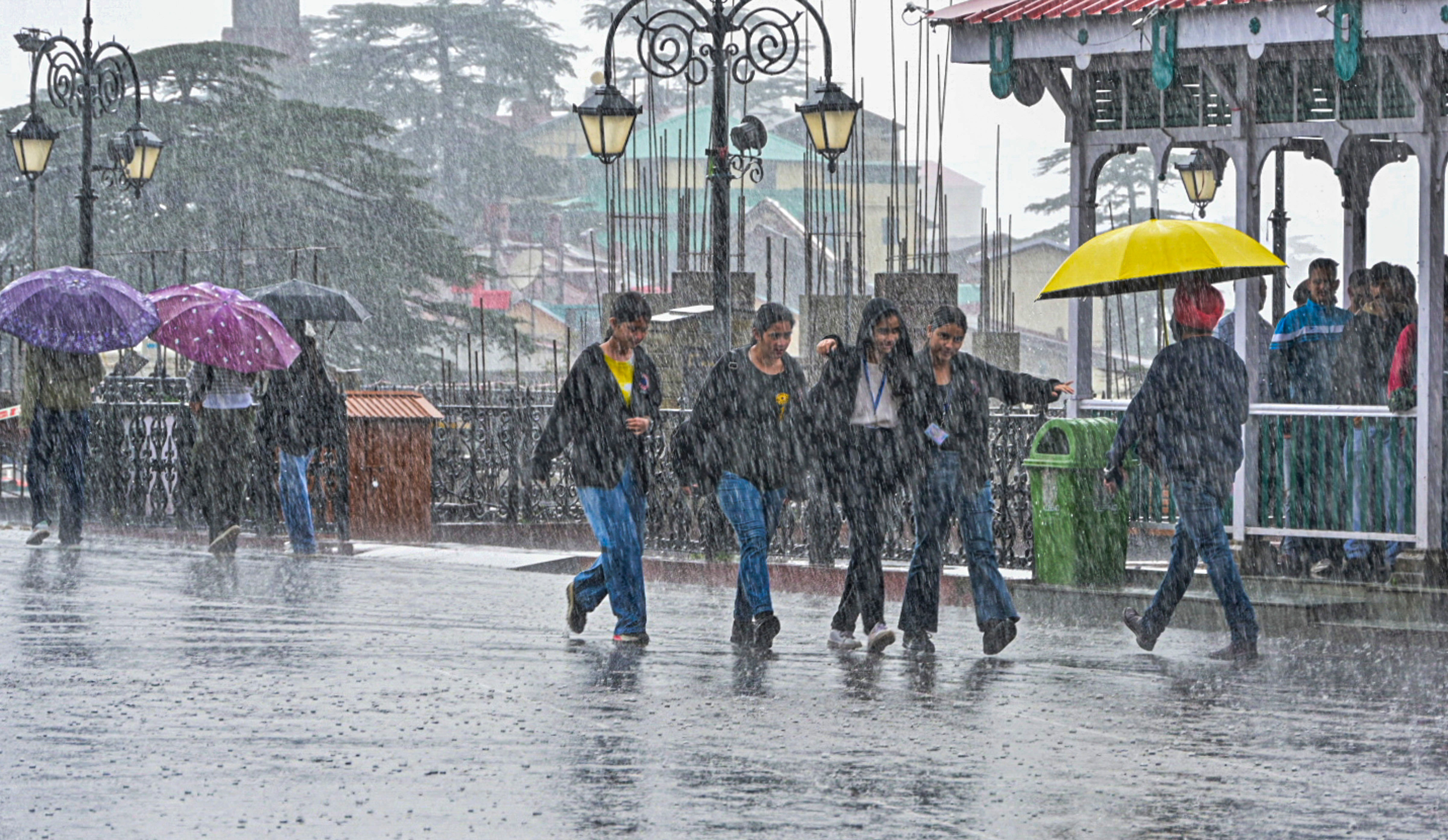 <div class="paragraphs"><p> People walk down a road during rain, in Shimla.</p></div>