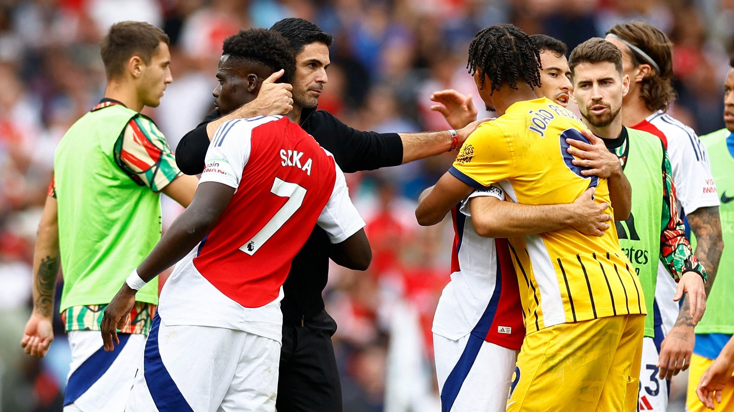 <div class="paragraphs"><p>Arsenal manager Mikel Arteta, Bukayo Saka and Gabriel Martinelli with Brighton &amp; Hove Albion's Joao Pedro after the match.</p></div>