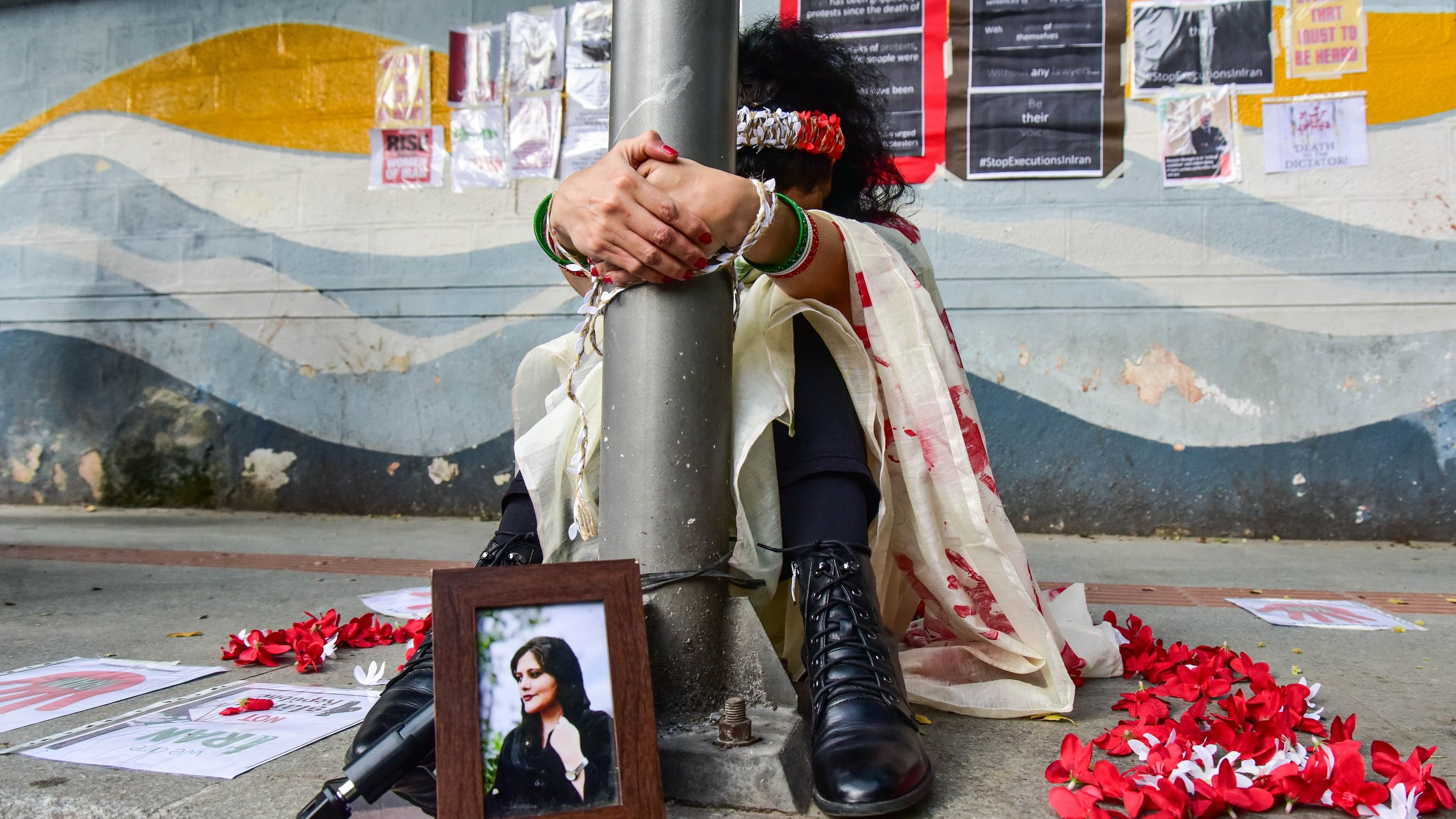 <div class="paragraphs"><p>A file photo of an Iranian expat woman who staged a silent demonstration in Bengaluru against atrocities back home.&nbsp;</p></div>