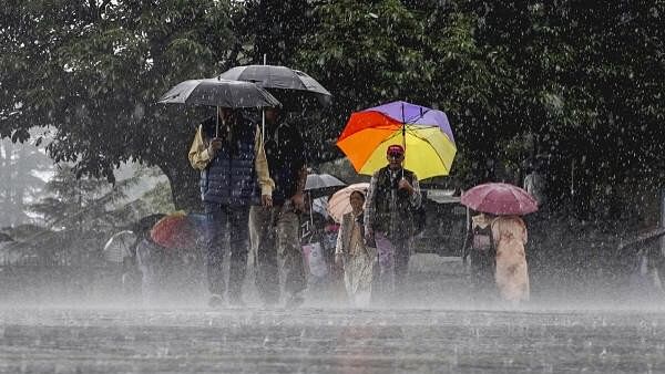 <div class="paragraphs"><p> People amid monsoon rains, in Shimla.</p></div>