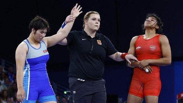 <div class="paragraphs"><p>Sol Gum Pak of North Korea reacts after winning her bout against Nisha Nisha of India.</p></div>