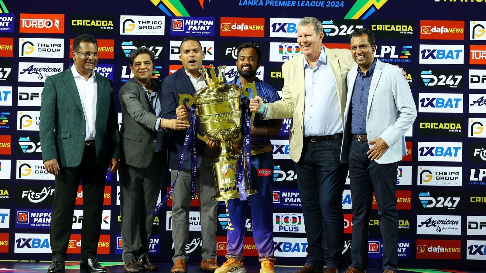 <div class="paragraphs"><p>ICC Chairman Greg Barclay (second from right), Sports Minister Harin Fernando (third from left) and IPG CEO Anil Mohan (second from left) give away the LPL trophy to Jaffna Kings' captain Charith Asalanka. SLC President Shammi Silva and Tournament Director Samantha Dodanwela are also seen in the picture. </p></div><div class="paragraphs"><p><br></p></div>