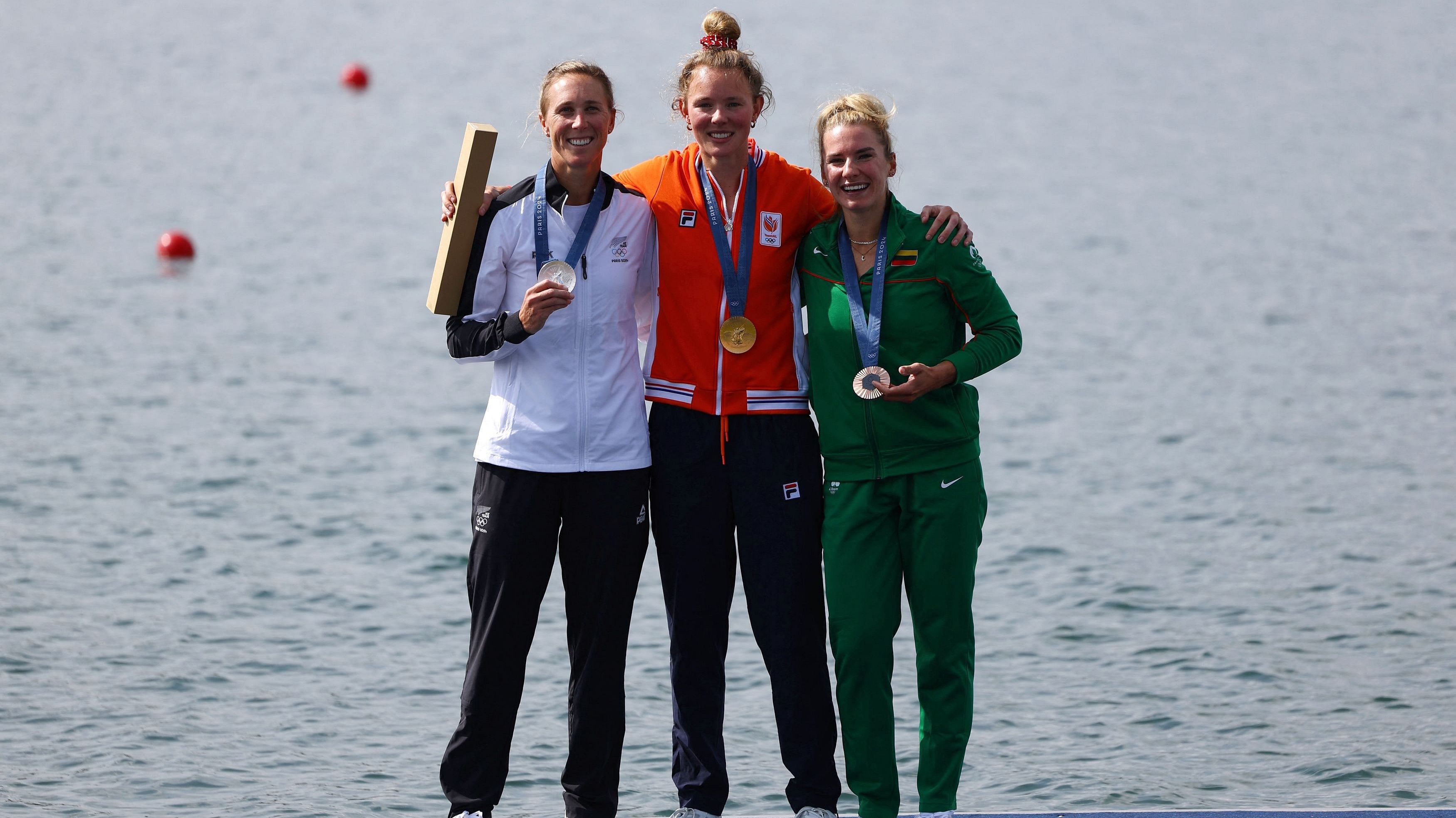 <div class="paragraphs"><p>Gold medallist Karolien Florijn of Netherlands celebrates on the podium after winning with silver medallist Emma Twigg of New Zealand and bronze medallist Viktorija Senkute of Lithuania.</p></div>