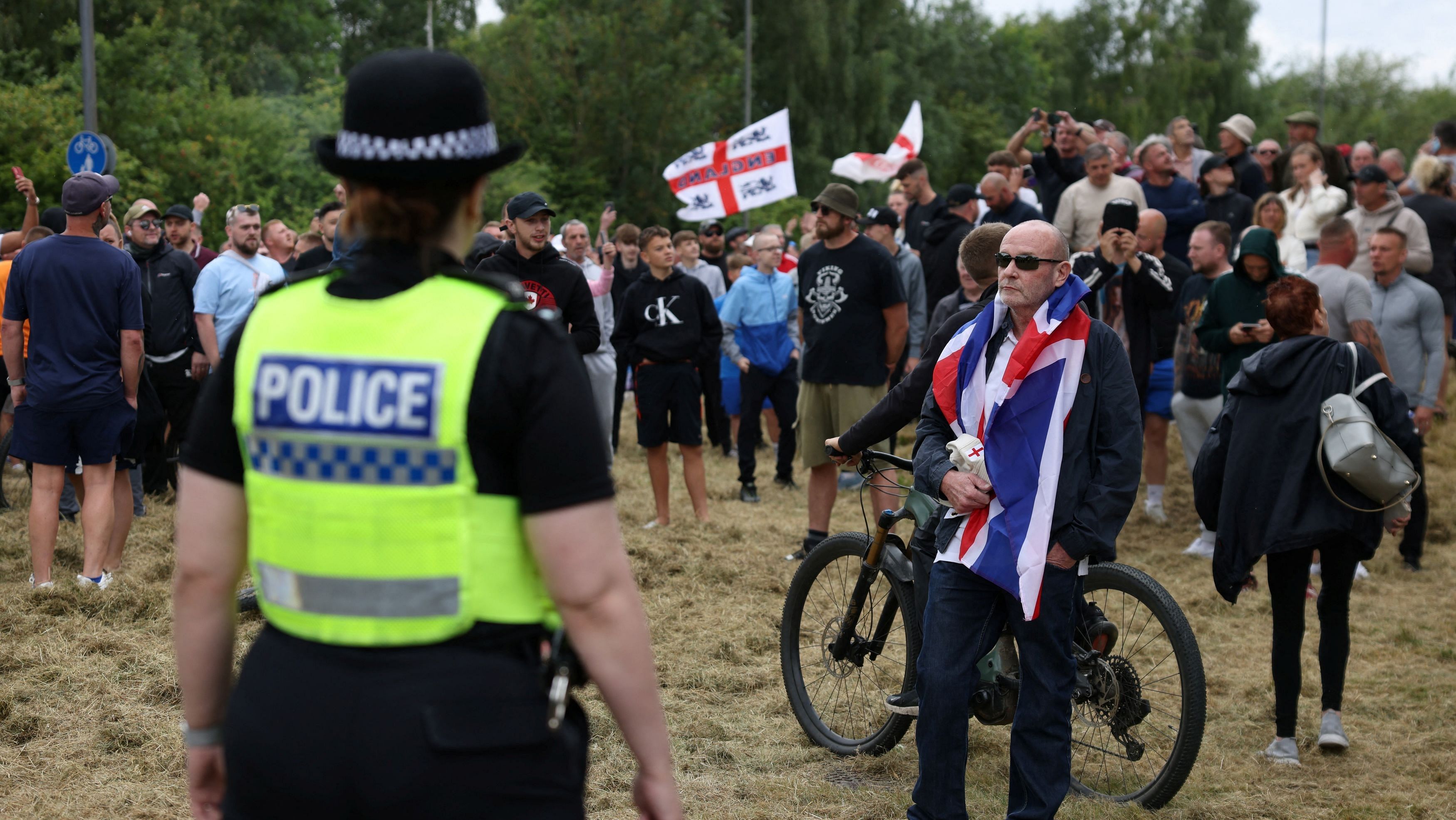 <div class="paragraphs"><p>A police officer stands guard facing towards anti-immigration protesters in Rotherham, Britain, August 4, 2024. </p></div>