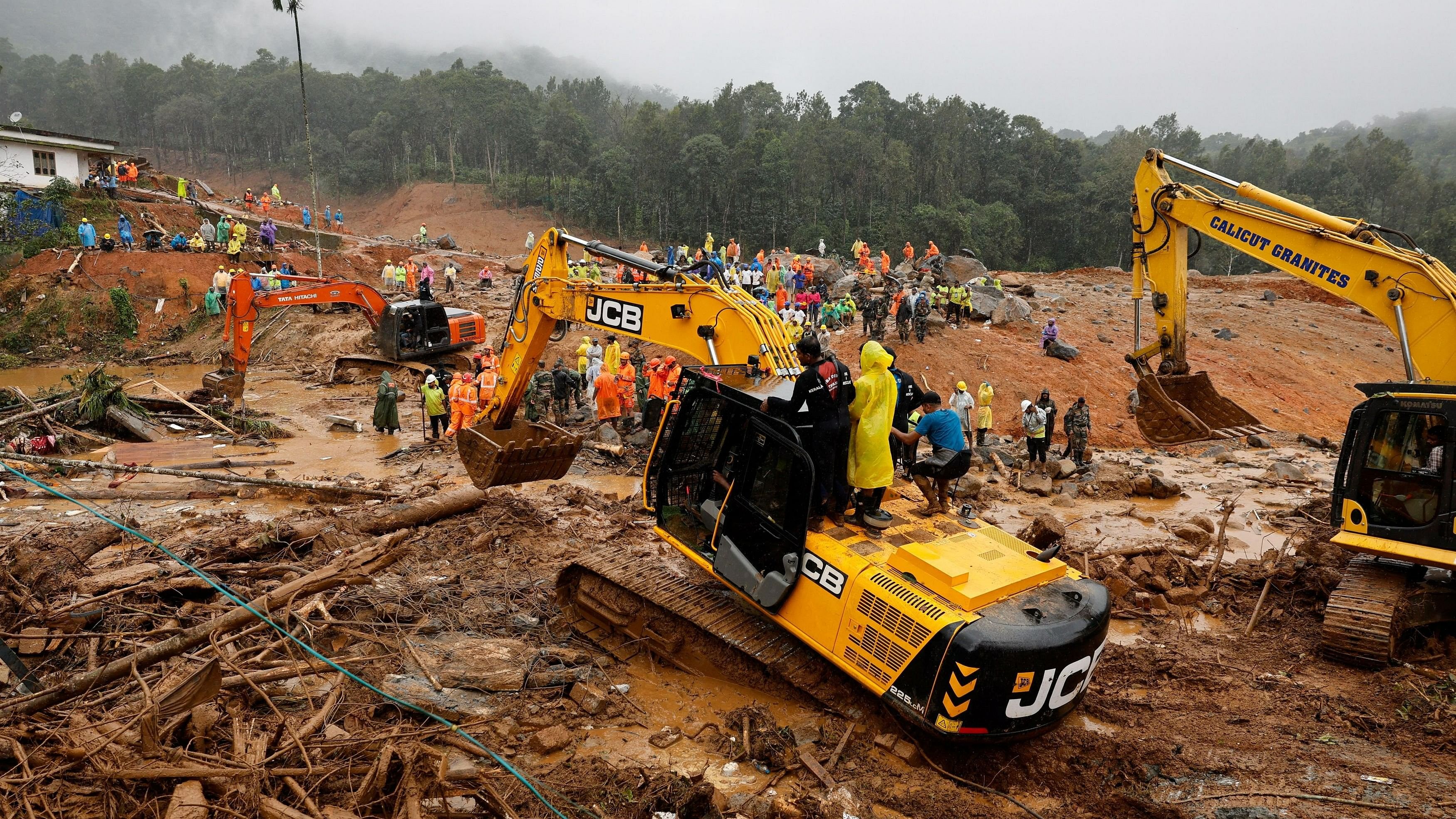 <div class="paragraphs"><p>People stand as search operations are carried out after landslides hit Mundakkai village in Wayanad district in the southern state of Kerala, India, August 1, 2024. </p></div>