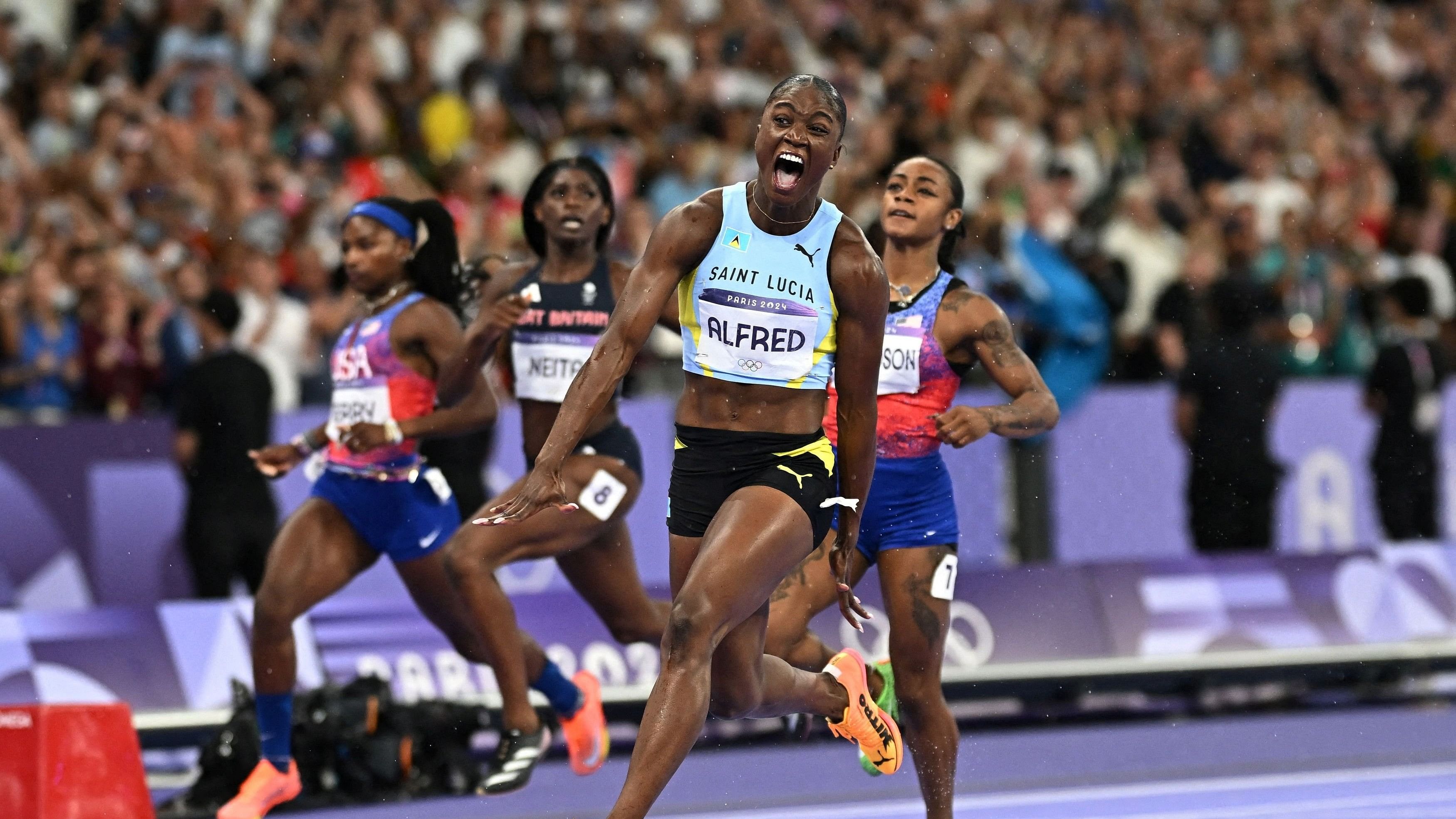 <div class="paragraphs"><p>Julien Alfred of Saint Lucia celebrates after crossing the line to win gold. </p></div>