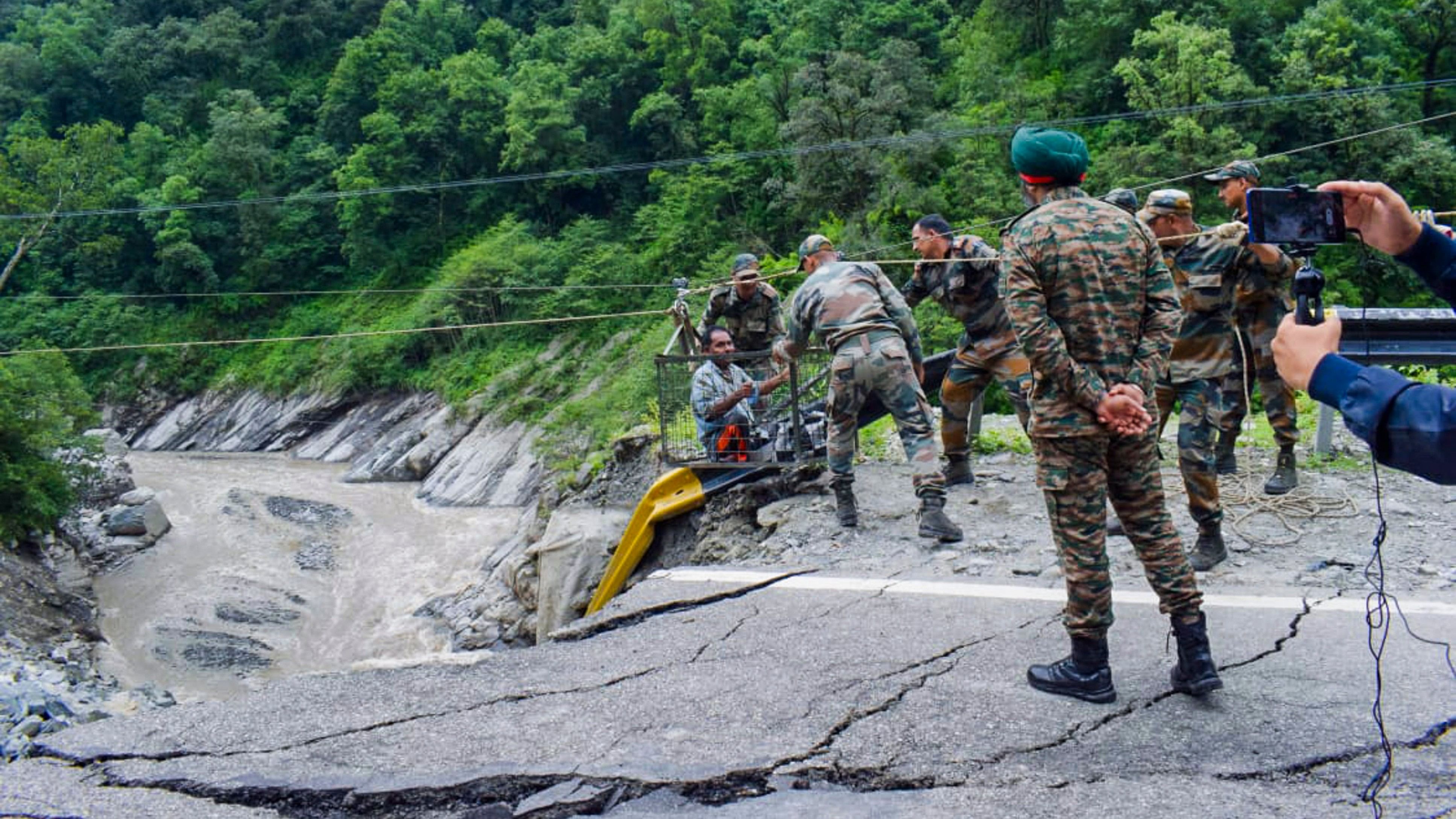 <div class="paragraphs"><p>Rescue operation underway after a portion of a road damaged by heavy monsoon rains on the Kedarnath Yatra route, in Rudraprayag district, Sunday, Aug. 4, 2024. </p></div>