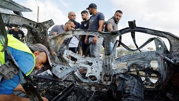 <div class="paragraphs"><p>Palestinians inspect a vehicle damaged in an Israeli airstrike, in Zeita, near Tulkarm, in the Israeli-occupied West Bank.</p></div>