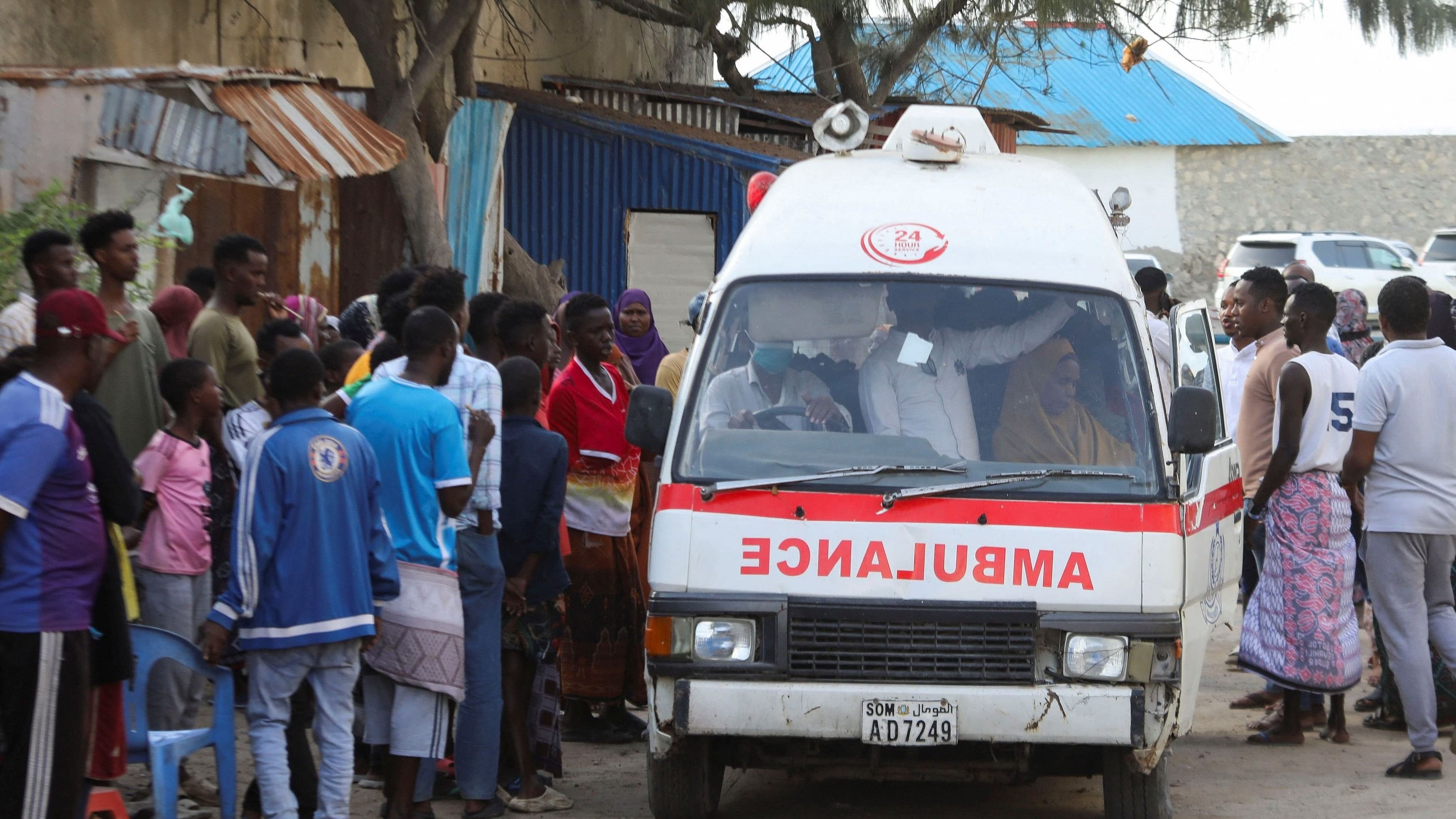 <div class="paragraphs"><p>People gather as an ambulance carries the dead body of an unidentified woman killed in an explosion that occurred while revellers were swimming at the Lido beach in Mogadishu.</p></div>