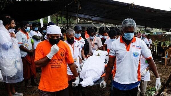 <div class="paragraphs"><p>Volunteers carry a body of a landslide victim to a crematorium in Meppadi, after landslides hit several villages in Wayanad district, in the southern state of Kerala.</p></div>