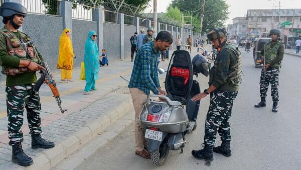 <div class="paragraphs"><p>Security personnel check a scooty rider during high alert on  anniversary of abrogation of Article 370  in Srinagar.</p></div>