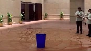 <div class="paragraphs"><p>Screengrab from a video shared by Congress leader Manickam Tagore showing a bucket placed in the Parliament building to collect water dripping from the leakage.</p></div>