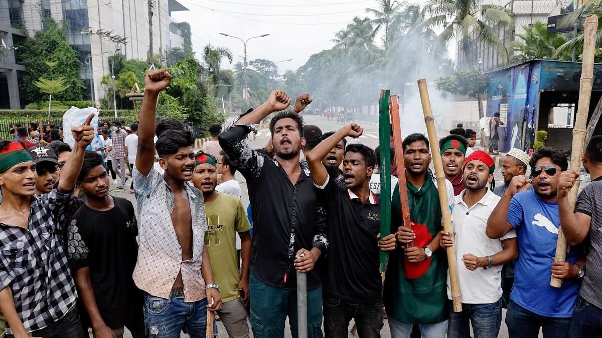 <div class="paragraphs"><p>Demonstrators shout slogans after they have occupied a street during a protest demanding the stepping down of Bangladeshi Prime Minister Sheikh Hasina, following quota reform protests by students, in Dhaka, Bangladesh, August 4, 2024. </p></div>