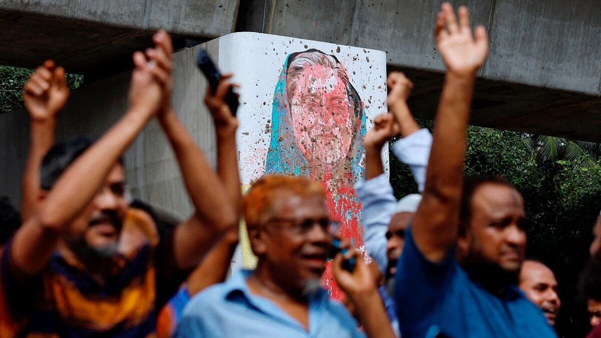 <div class="paragraphs"><p>A mural of Prime Minister Sheikh Hasina is seen vandalised by protesters as people celebrate her resignation in Dhaka.</p></div>