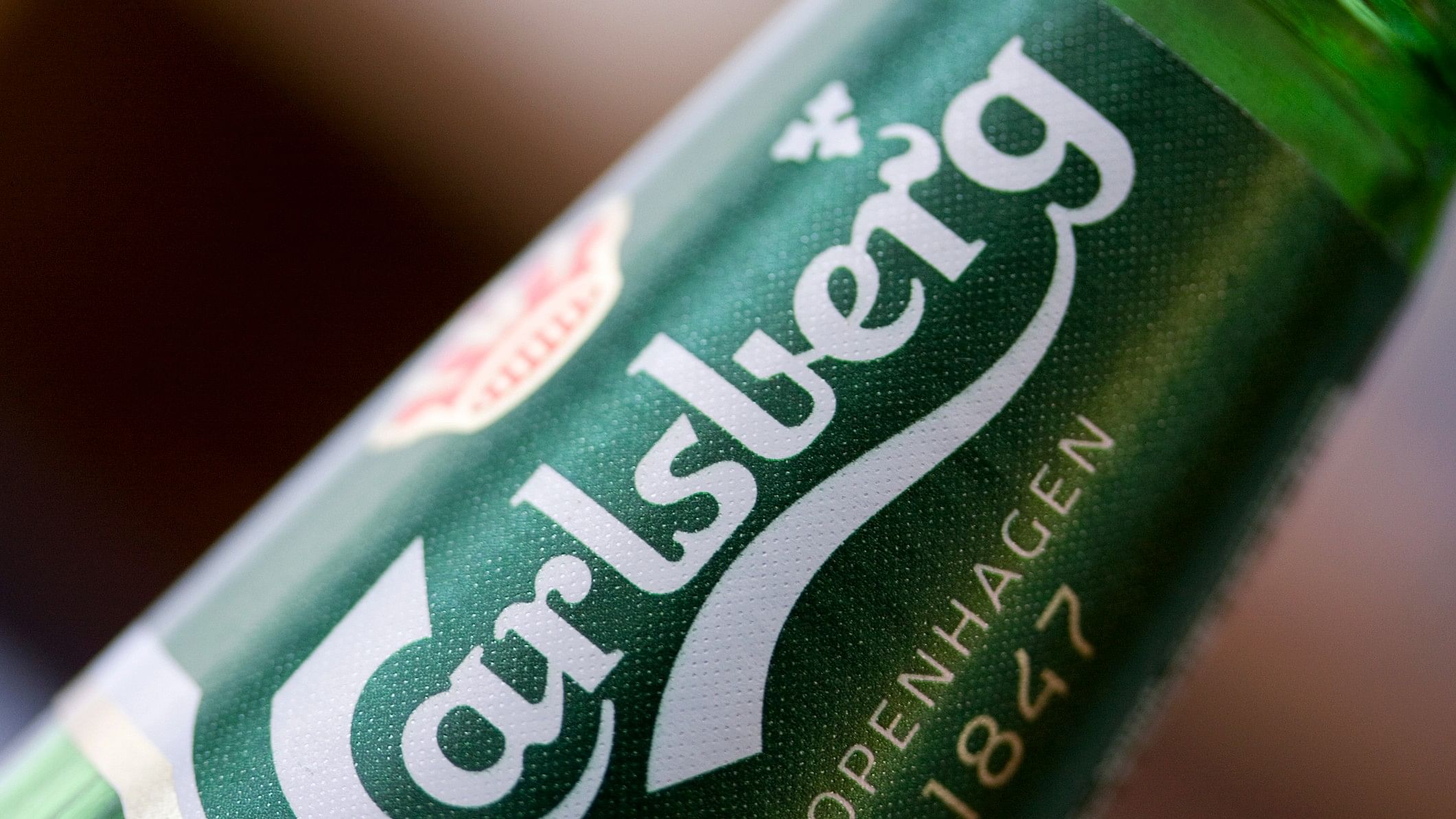 <div class="paragraphs"><p> Close up of Carlsberg beer logo on a glass bottle.</p></div>