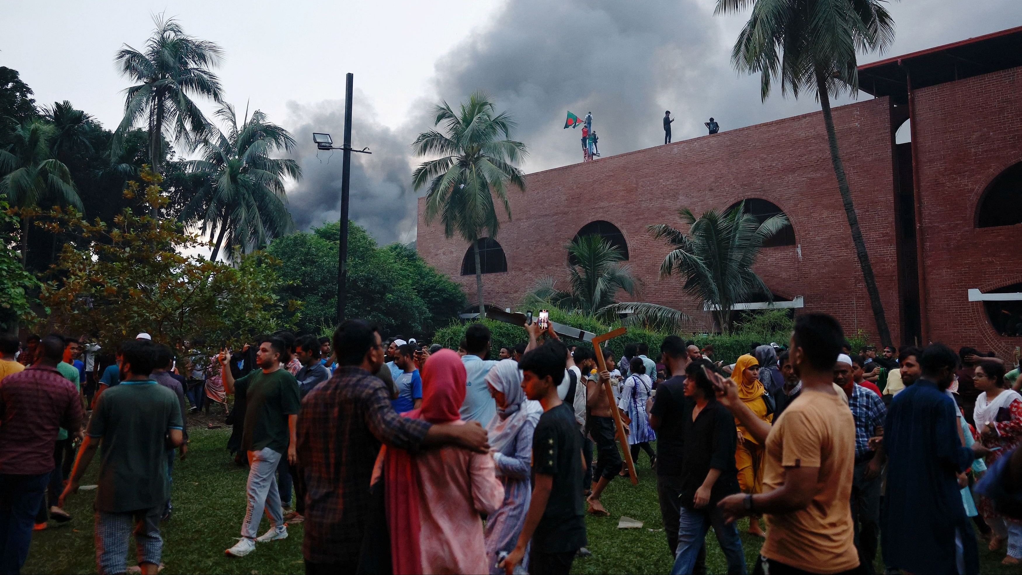 <div class="paragraphs"><p>Smoke rises as people set fire to a vehicle inside the Ganabhaban, the prime minister's residence, after the resignation of Prime Minister Sheikh Hasina in Dhaka, Bangladesh, August 5, 2024. </p></div>