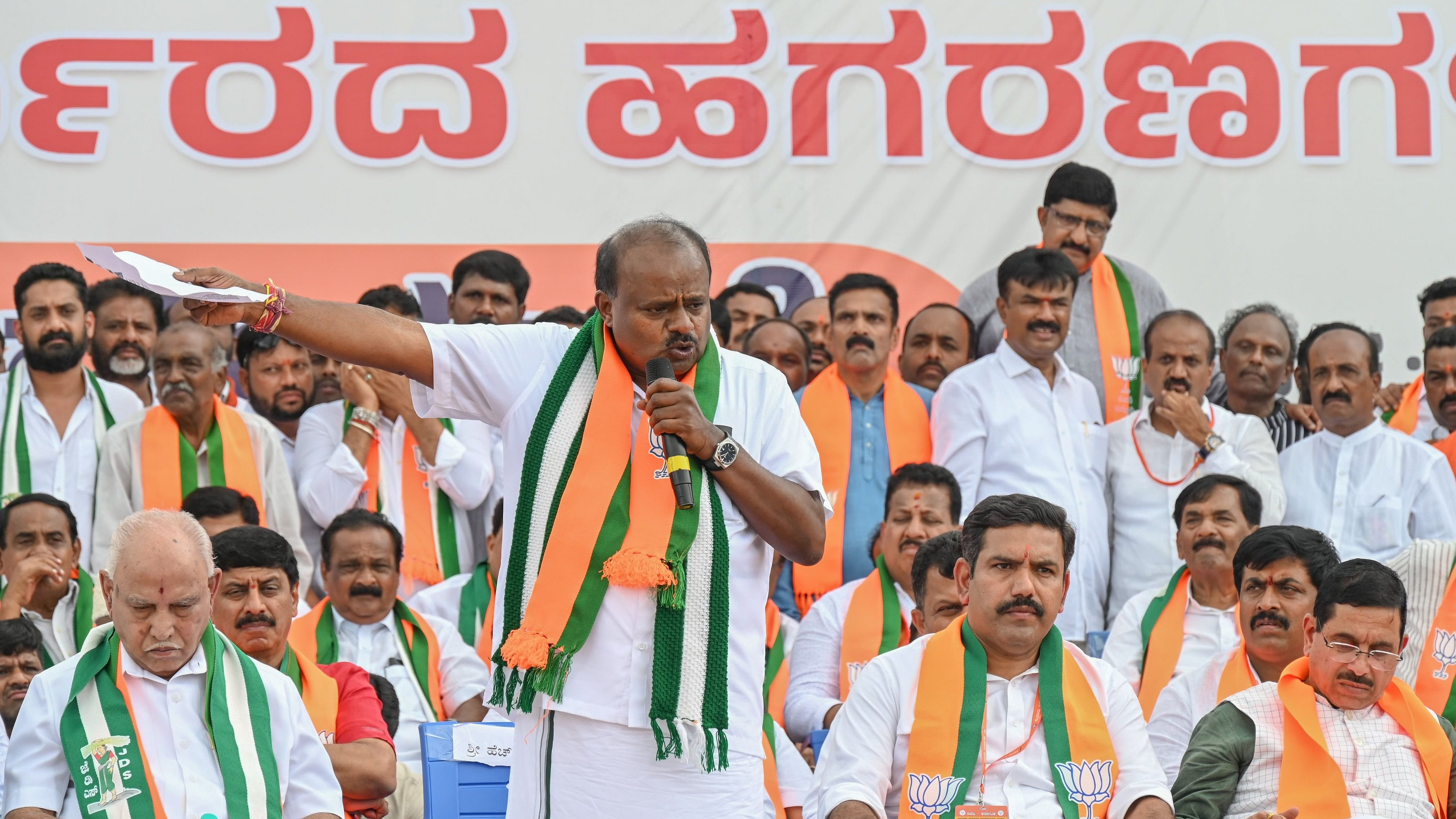 Union minister H D Kumaraswamy speaks during the BJP-JD(S) padayatra on Kengeri NICE Road in Bengaluru on Saturday. BS Yediyurappa (first from left) and BJP state chief B Y Vijayendra (second from right) are also seen. DH Photo/S K Dinesh