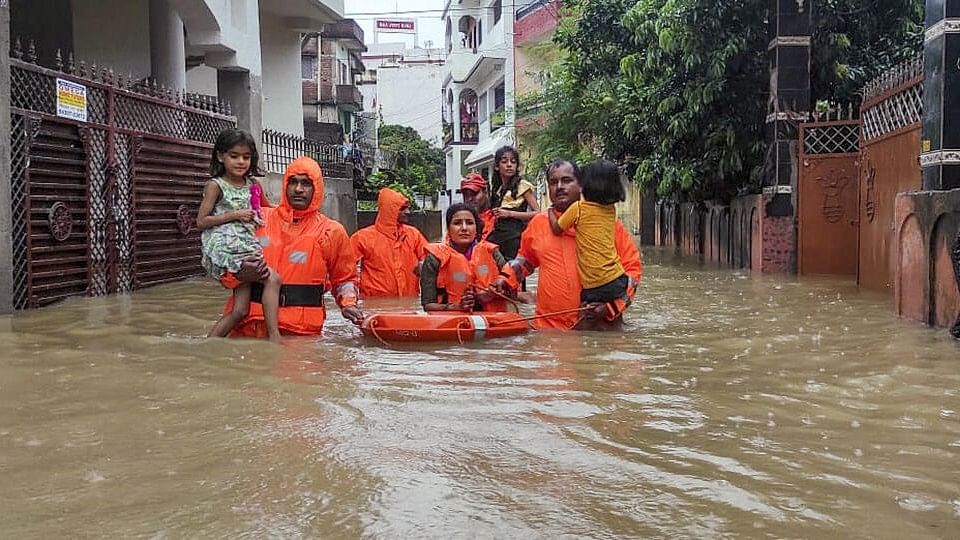 <div class="paragraphs"><p>NDRF personnel rescue people from their flood-affected residence after heavy rains, in Ranchi.</p></div>