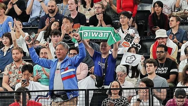 <div class="paragraphs"><p>A supporter holds a towel rreferencing Taiwan during a badminton match.</p></div>