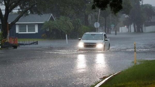 <div class="paragraphs"><p>A vehicle drives through high water in the Shore Acres neighborhood located on the Tampa Bay while Tropical Storm Debby moves up the gulf coast in St. Petersburg, Florida, US.</p></div>