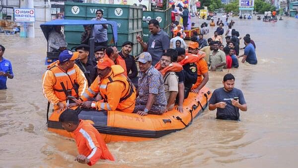 <div class="paragraphs"><p>Vijayawada City Police Commissioner IPS SV Rajasekhara Babu with others reviews the rescue operation at a flood-affected area after heavy rainfall.</p></div>