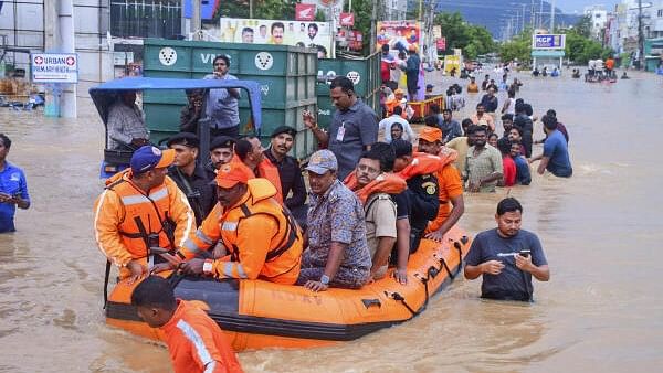 <div class="paragraphs"><p>Vijayawada City Police Commissioner IPS SV Rajasekhara Babu with others reviews the rescue operation at a flood-affected area after heavy rainfall, in Vijayawada.</p></div>