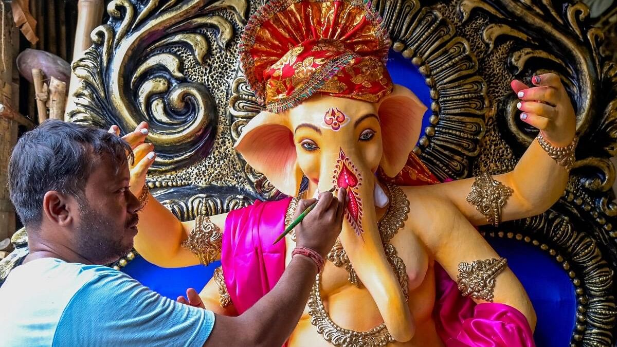 <div class="paragraphs"><p>An artisan gives final touches to an idol of Lord Ganesh ahead of 'Ganesh Chaturthi' festival.</p></div>