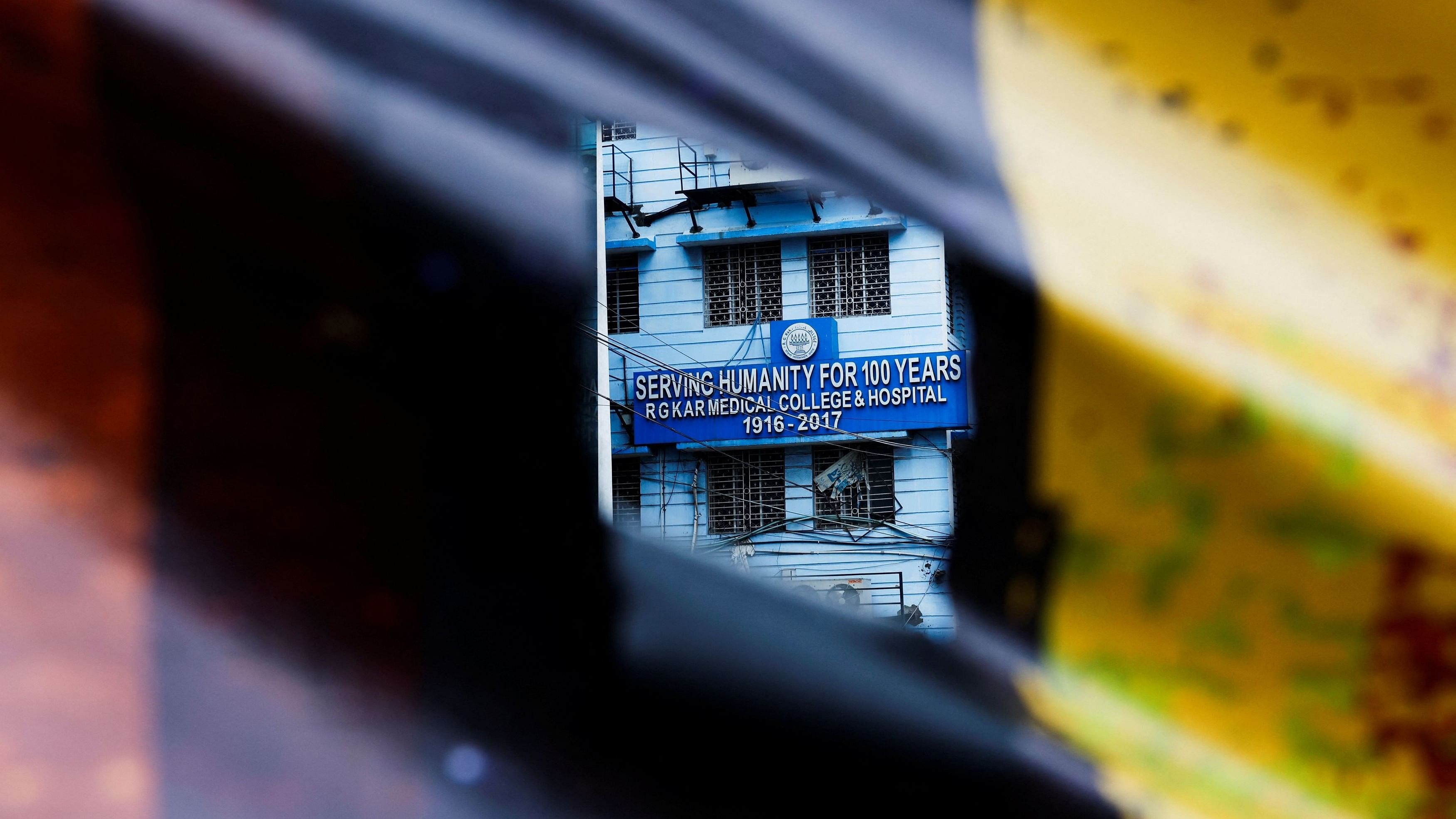 <div class="paragraphs"><p>A signboard of R G Kar Medical College and Hospital is seen through a poster hanging on a closed gate in Kolkata, India, August 19, 2024. </p></div>