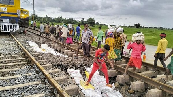 <div class="paragraphs"><p>Workers restore a portion gravel under the railway track after it was washed away due to floodwaters at Kesamudram, in Mahabubabad district.&nbsp;</p></div>