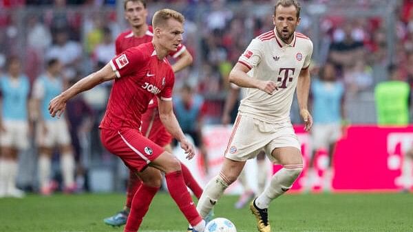 <div class="paragraphs"><p>Bayern Munich's Harry Kane in action with SC Freiburg's Lukas Kubler.</p></div>