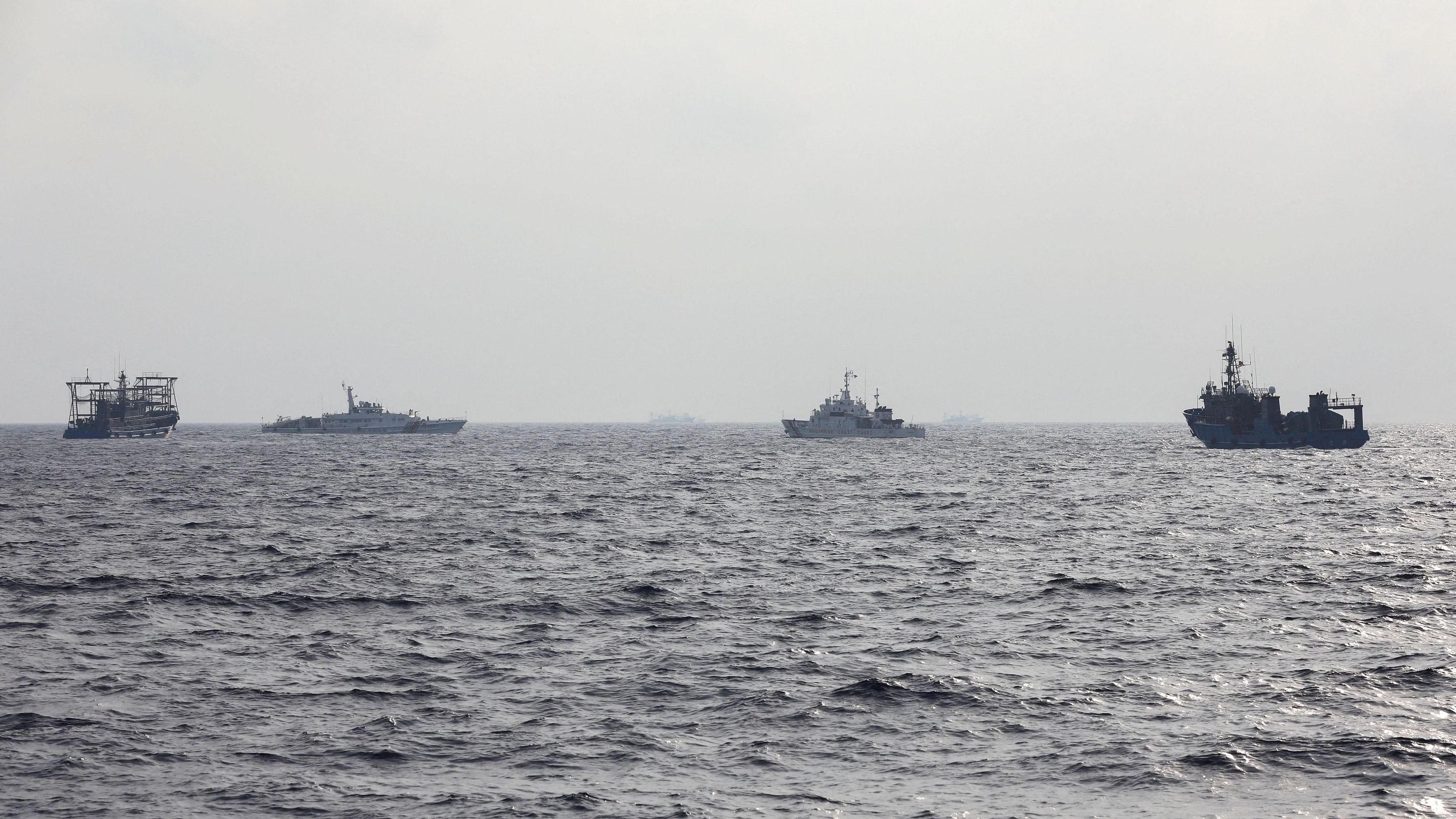 <div class="paragraphs"><p>A Philippine Coast Guard ship is seen surrounded by Chinese maritime militia vessels and a Chinese Coast Guard ship during a resupply mission for Filipino troops stationed at a grounded warship in the South China Sea.</p></div>