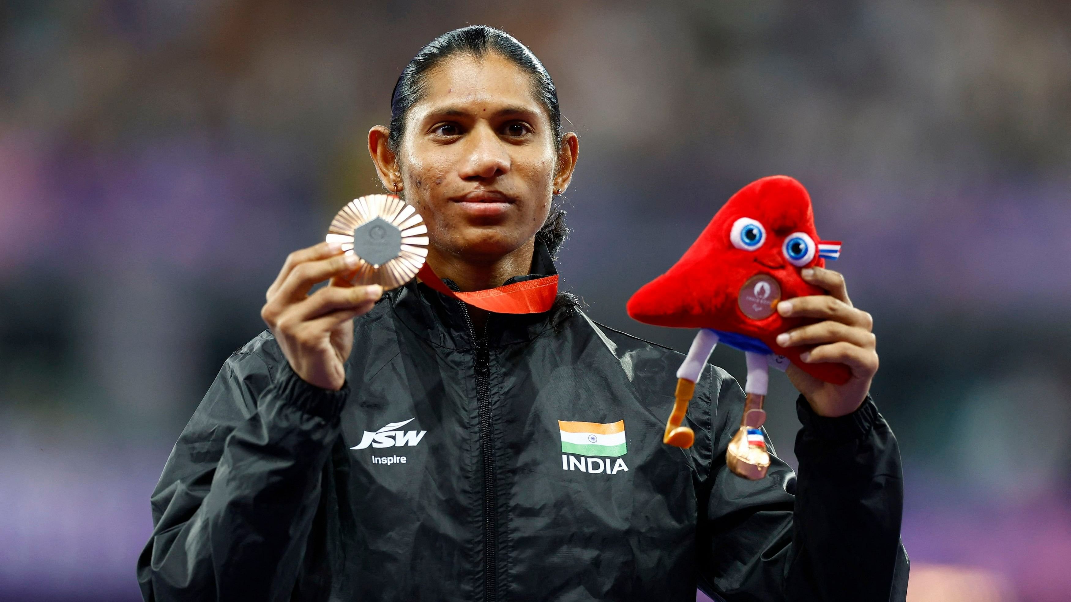 <div class="paragraphs"><p>Bronze medallist Deepthi Jeevanji of India celebrates on the podium </p></div>