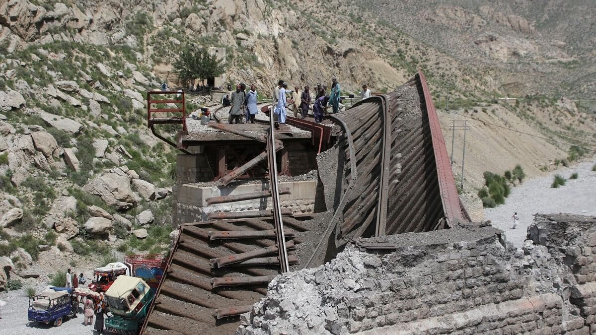 <div class="paragraphs"><p>Workers stand on damaged railway tracks as they repair them, a day after separatist militants conducted deadly attacks, in Bolan district of Pakistan's restive province of Balochistan, Pakistan August 27, 2024.</p></div>