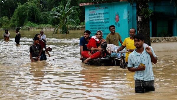 <div class="paragraphs"><p>People move a cart with a woman and child through a flooded street, in the Fazilpur area of Feni, Bangladesh, August 26, 2024. </p></div>