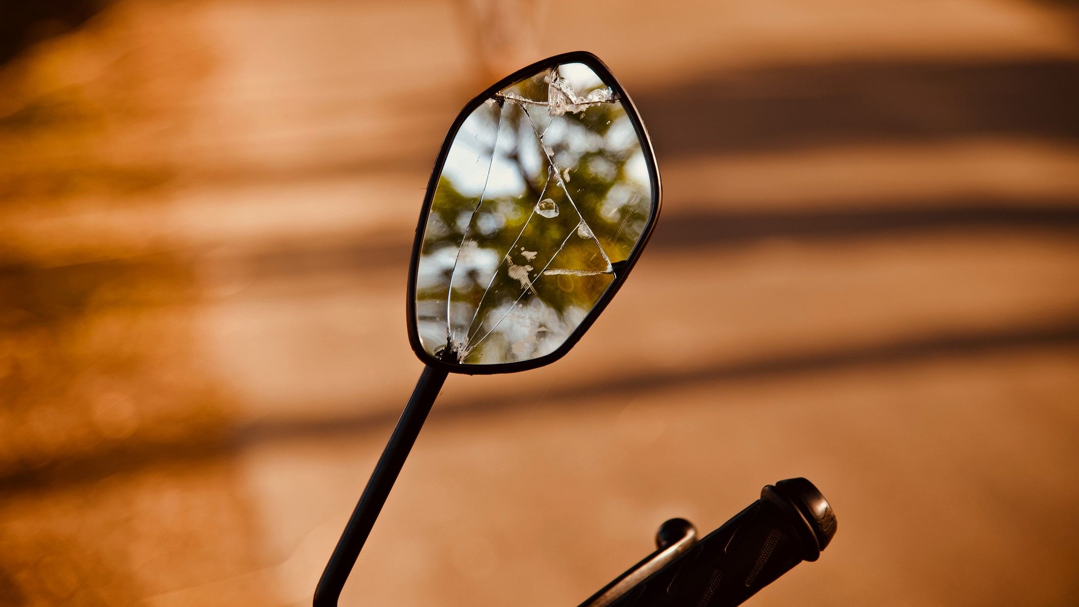 <div class="paragraphs"><p>Representative image showing broken mirror of a scooter.</p></div>